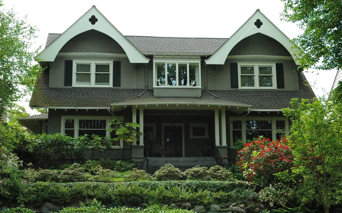 Gray two-story house with dual front gables and a dark shingle roof