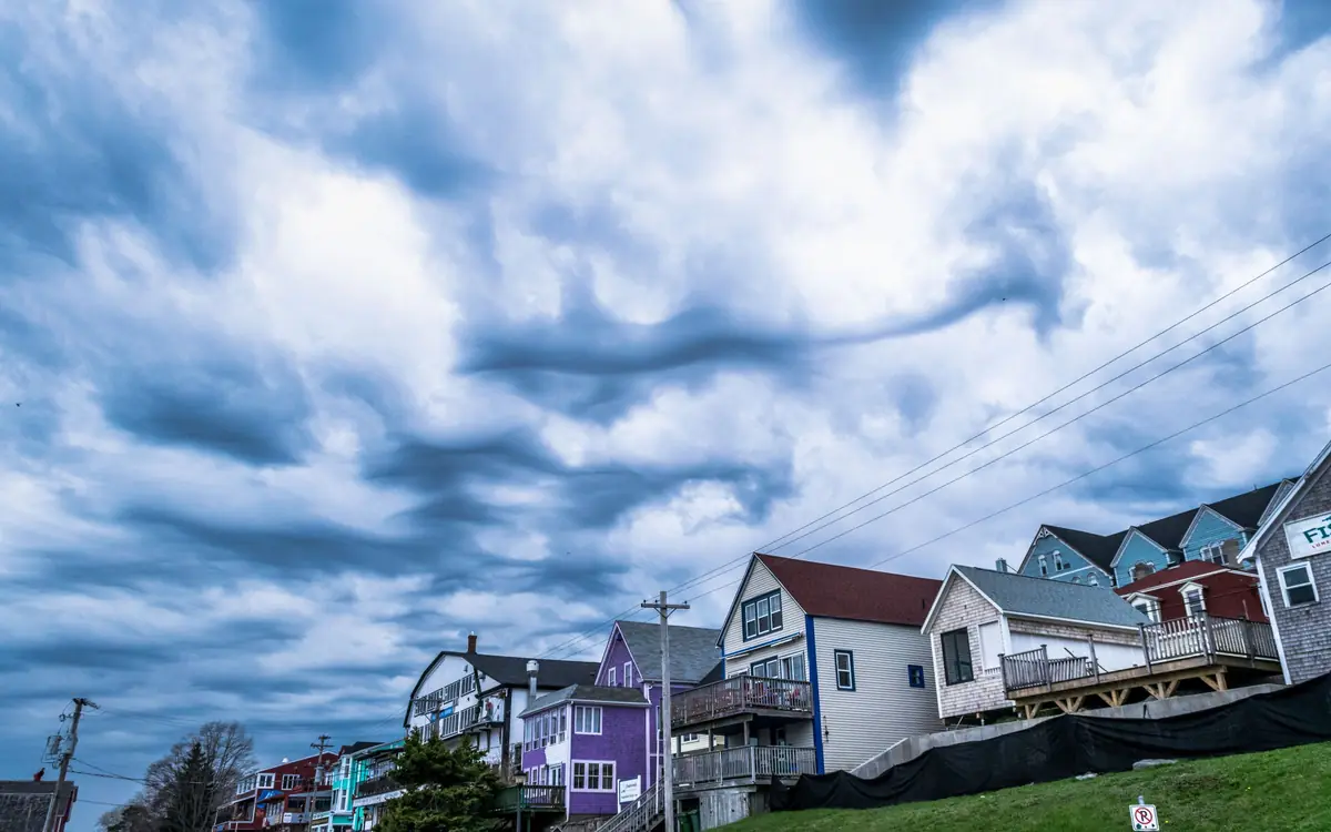 Dark storm clouds moving over a row of houses