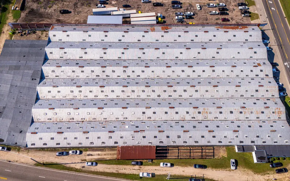 Aerial view of a large commercial building with a flat membrane roof