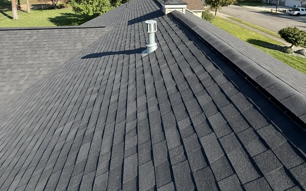 New dark architectural shingle roof with a ridge vent